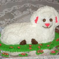 Easter Lamb white cake with bc icingmy 3 boys (10,5 amd 4) was dying to help so they did the grass and flowers around the lamb