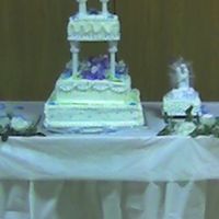 1St Wedding Cake not to good of a picture thank god!! This was my my first wedding tiered cake and honestly it didnt look to great! But thats why it was...