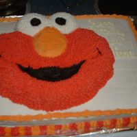 Elmo Elmo cake on top of a sheet cake that i did for a coworker. His nephew turned 2 and is obsessed with Elmo. He needed a cake for 30 people....