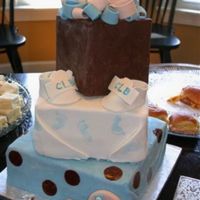 Baby Shower Cake My first completely fondant covered cake. I was trying to scale down a cake from a picture picked from the internet. My bottom tier was too...