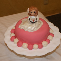 Maddie's Baptism Cake Fondant covered and fondant figure. Large main cake did not survive my daughter's (Maddie's mom) driving.