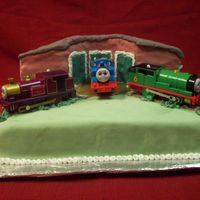 Thomas Train Yard The cake is covered in fondant. The train cars are toys my neighbor had; the cake was for her son.