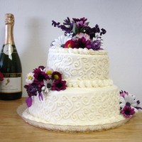 Purple Flowers Small wedding cake with purple flowers and buttercream frosting. My 1st atempt at scroll work.