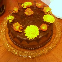 Chocolate Mother's Day Cake Triple chocolate cake with raspberry filling & chocolate ganache. Decorated with fresh calendula flowers and piped chocolate hearts