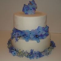 2 Tier Fondant Cake With Silk Flowers This is one of my first wedding cakes. OK for a first try, I guess.