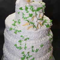 Cala Lily Wedding Cake 4 tier wedding cake covered in buttercream, piped scrollwork. Gumpaste Cala lilies & Butterflies.