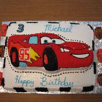 Lightning Mcqueen 2 layer cake. Character cake on top of sheet race track.