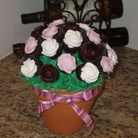 Bouquet Mini cupcake bouquet. Dark chocolate fudge cake with chocolate icing and vanilla buttercream icing. I used a 6 inch flower pot, and tip 1M...