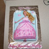 Pretty As A Princess Strawberry cake with strawberry filling on 9x13 cake. Dress is half of the football pan. Iced in bc. Doll is full sized and covered with...