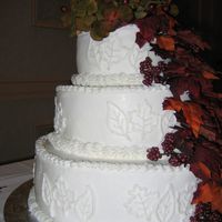 Fall Wedding Cake This is my first wedding cake ever! 3 tiers - 12", 9", 6". Buttercream frosting with white on white leaf piping. Silk...