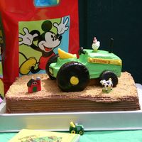 John Deere Tractor Oops, didn't mean to send the super close up..., tractor and tires are frosted (with yellow fondant accents).