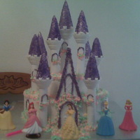 Princess Birthday Cake Cake is white w/butter cream frosting. tips of castel are of purple sprinkles