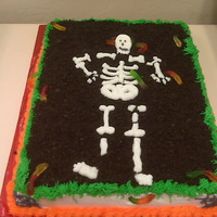 Halloween 2009 Cake is chocolate w/butter cream frosting with crushed oreo's as dirt, skeleton made of gum paste.