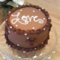 Love Cake This is a 6 layer chocolate cake, frosted with chocolate buttercream and done with reverse shells. The bride loved it!