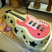 Girls Rock Pink Guitar I used Wilton guitar cakepan and wilton guitar pattern.White cake with strawberry filling and buttercream icing.Fondant guitar and accents...