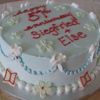 57Th Wedding Anniversary Vanilla and chocolate fudge marble cake with chocolate filling and buttercream icing. White chocolate 'flowers' and 'books&#...