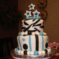 Topsy Turvy French Vanilla cake with raspberry filling, covered in MMF.