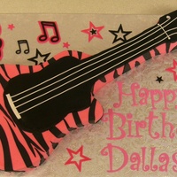 Dallas's Guitar made from a 11x15 cake, buttercream with fondant stripes. Letters cut with the cricut