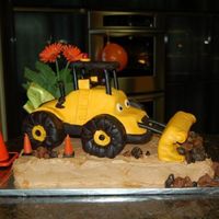 Loader Cake 12 X 18 sheet cake with BC frosting, 3D cruiser pan, carved, with BC and MMF. MMF and chocolate MMF accents. My first real cake ever for my...