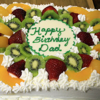 Fresh Fruit Sponge Cake 9x3 scratch sponge cake - filled with whipped cream and chopped kiwi and strawberries. Topped with more fruit and a white chocolate plaque...
