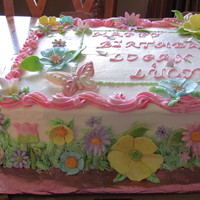 Flowers And Butterflies Vanilla cake with strawberry cream filling, buttercream frosting with fondant flowers and white and pink chocolate butterflies