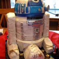 R2D2 My First Big 3D cake.Chocolate cake peanutbutter cream filling,Yellow cake raspberry cream filling.The legs are crispy cereal.covered and...