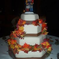 Fall Wedding Cake This is a four-tier three-layer wedding cake. Tiers alternate in flavor, bottom is white cake, top is dark chocolate. Each tier is covered...