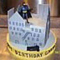 Batman In Gotham City 10" square chocolate cake. Buttercream icing with MMF buildings. Batman action figure and car added. I'm sorry I don't...
