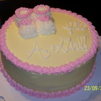 Baby Shower Girl White chocolate cake with buttercream icing. Baby booties are BC covered marshmallows.