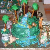 Jungle Cake My daughter's 7th birthday jungle cake. Seemed to take forever to get it decorated with all the critters and palm trees, but it was...