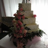 Sara's Wedding Cake 4 tier White cake, white buttercream, off-white accents with silver dragees. Fresh pink roses. This cake tipped over while placing on the...