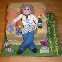 Retirement 7" cake cut to shape and covered in fondent icing with some decorations made from flower paste