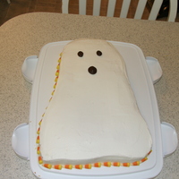 Ghost Cake Quick cake I did to take to my sons school. All buttercream and I used candy corn around the edges.