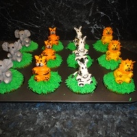 Figure Piped Jungle Animal Cupcakes Vanilla cupcakes with buttercream icing. My first figure piping :) Was for my cousin's baby shower.