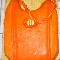 Purse Orange cake with buttercream icing and filling covered with MMF.