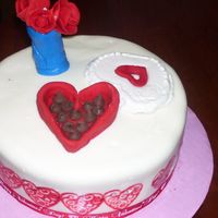 Chocolate And Roses Strawberry cake with white chocolate icing and MMF covering, flowers and chocolate box made from gumpaste with chocolate chip chocolates....