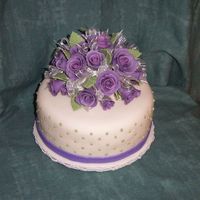 Purple Gumpaste Roses Cutting cake made for a friend's cupcake wedding. Fondant covered WASC with raspberry filling.
