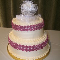 Jeans Wedding Cake This is only my 4th wedding cake. For my friend Jean. All white cake with ivory buttercream. Flowers are royal icing with pearl sugar beads...