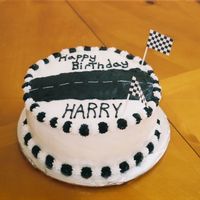 Cars Fan Chocolate cake with vanilla BC icing. Writing needs improvement.