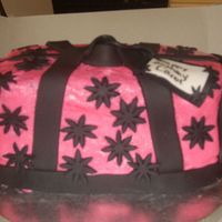 Flower Purse Cake This was my first time trying to make a purse cake and I made it for my boss. Covered in BC( i think i made it a little to thin) everythin...