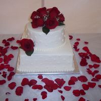 Sm_Wed.jpg 11 inch square and 8 inch round. Buttercream frosting and real roses. Made for one of my husbands co workers who ws having a small wedding...