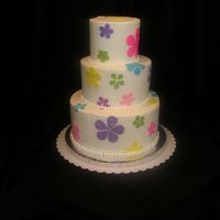 Flower Power a spring flower power cake for my hubbys work. Wanted to make something bright and cucte! This is a 4,6,8 inch round. Iced in bc with...