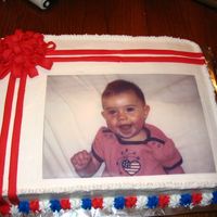 My Daughters Adoption Finalization! A friend and I did a sheet cake 1/2 yellow and 1/2 chocolate. My daughters picture is made with an edible icing transfer. The bow and...