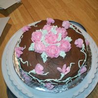 Rose Cake Chocolate cake with stabalized whipping cream filling. Iced in Chocolate icing, roses done with wilton buttercream.