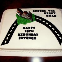 Which Road? All buttercream icing with fondant accents to an 18th birthday. Customer provided the motorcyle for us to use.