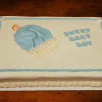 Sweet Baby Boy Shower cake is decorated in buttercream with fondant accents.