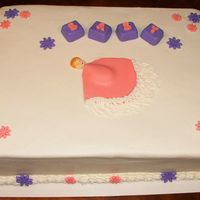 Baby Block Daisy White Buttercream with purple and pink fondant accents. The hand-painted baby and blocks were created using fondant.