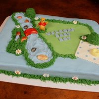 Winnie's Outdoor Adventure All buttercream with fondant accents and a plastic Winnie the Pooh figure. Winnie enjoys an outdoor adventure fishing in the creek and...