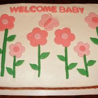 Daisy Pink Buttercream with light and dark pink fondant accents complete this girls/baby shower cake.
