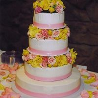 Ribbon And Roses A 14-10-8-6 French Vanilla and Chocolate tiers with pink ribbon and fresh roses. The icing was so much smoother at home and then wrinkled...